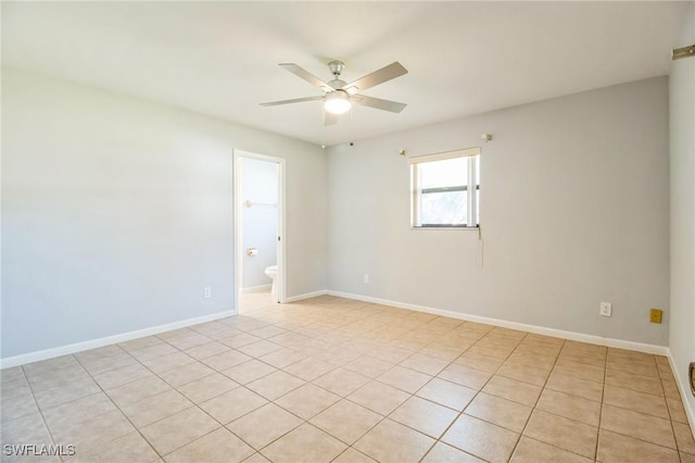 tiled empty room featuring ceiling fan