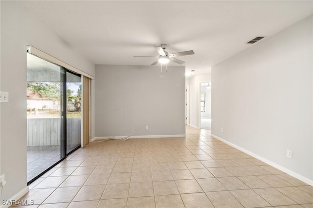 spare room featuring light tile patterned floors and ceiling fan