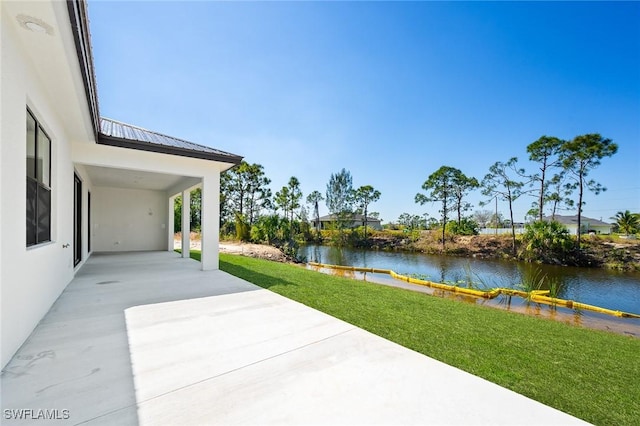 view of patio with a water view