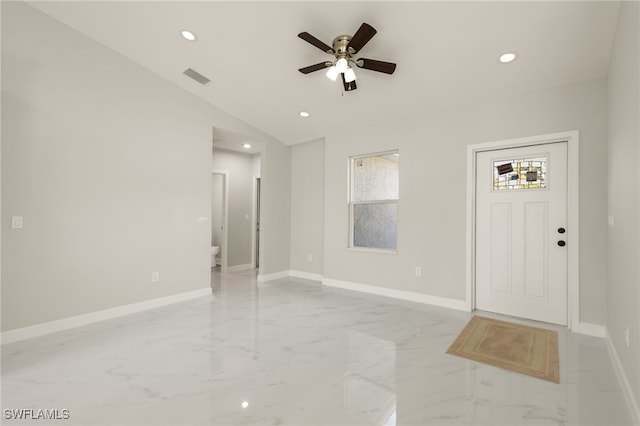 foyer entrance featuring ceiling fan and vaulted ceiling