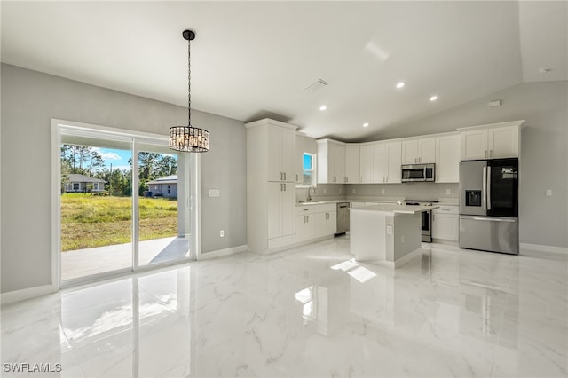 kitchen with white cabinetry, a center island, vaulted ceiling, and appliances with stainless steel finishes