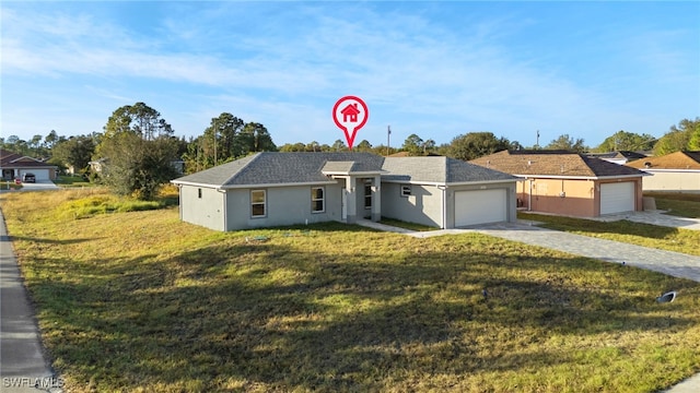 ranch-style house featuring a front lawn and a garage