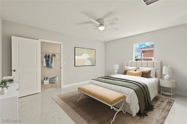 bedroom with a walk in closet, a closet, and ceiling fan