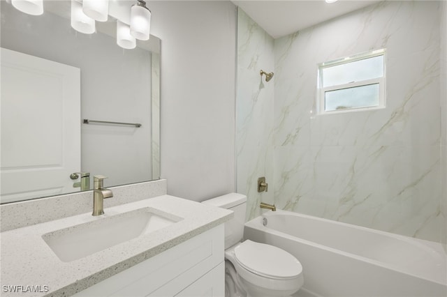 full bathroom with vanity, tiled shower / bath combo, and toilet