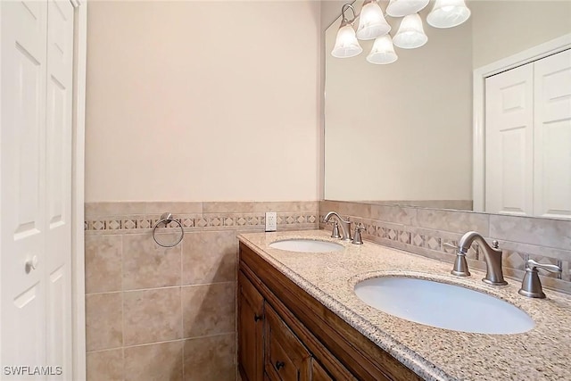 bathroom with vanity and tile walls