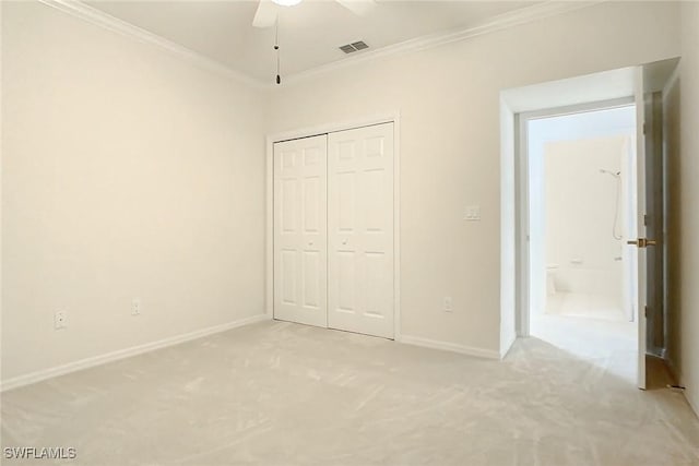 unfurnished bedroom with ceiling fan, crown molding, light carpet, and a closet