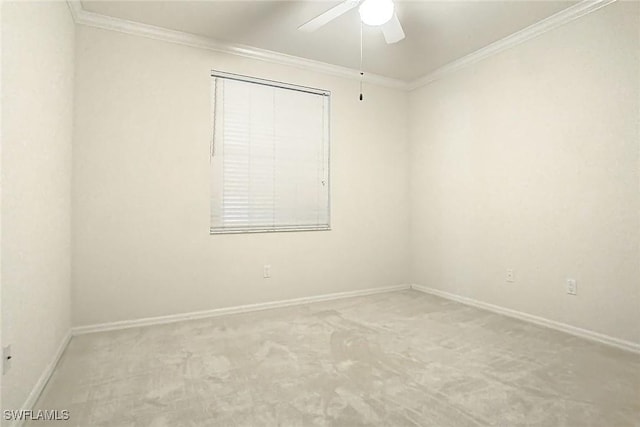 carpeted empty room featuring ceiling fan and ornamental molding