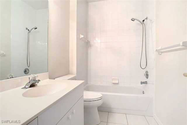 full bathroom featuring tile patterned floors, vanity, toilet, and tiled shower / bath combo