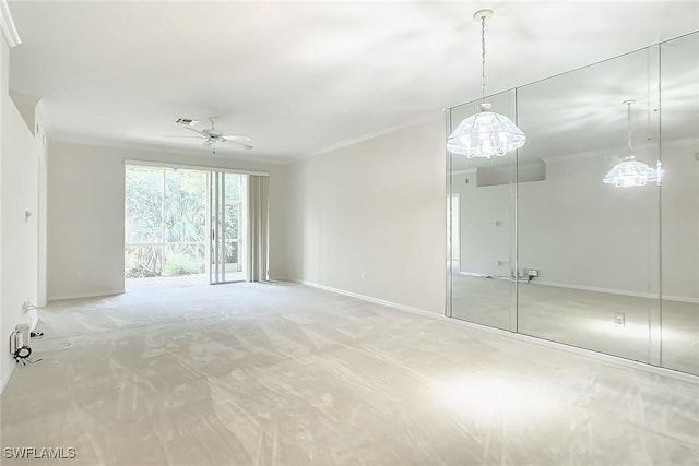 interior space featuring carpet, ceiling fan, and crown molding