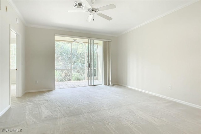 carpeted empty room featuring ceiling fan and crown molding