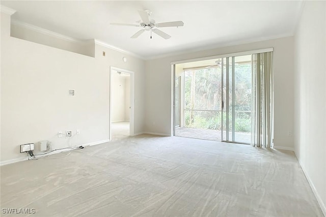 spare room with ceiling fan, light colored carpet, and ornamental molding