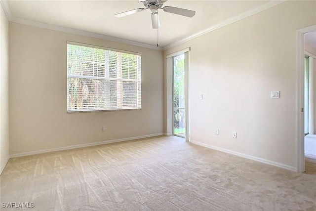 empty room with ceiling fan, crown molding, and light carpet