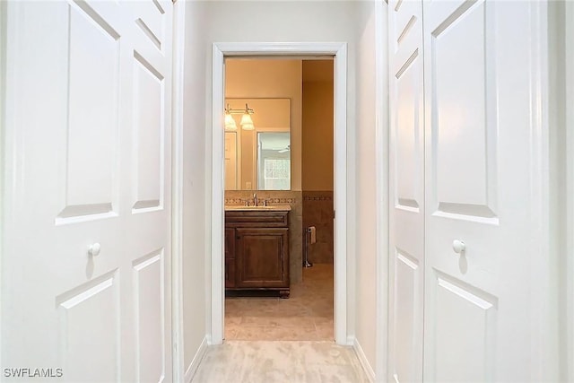 corridor featuring light tile patterned floors