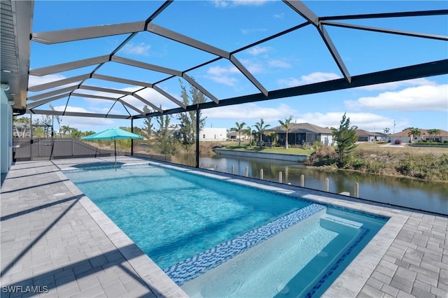 view of swimming pool featuring a lanai, a patio, and a water view