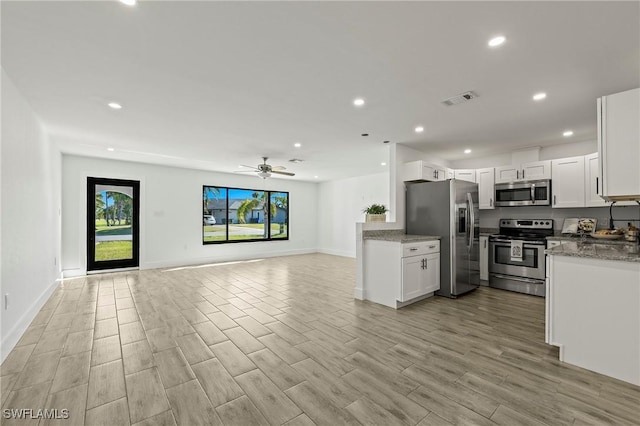 kitchen featuring ceiling fan, white cabinetry, appliances with stainless steel finishes, and light hardwood / wood-style flooring