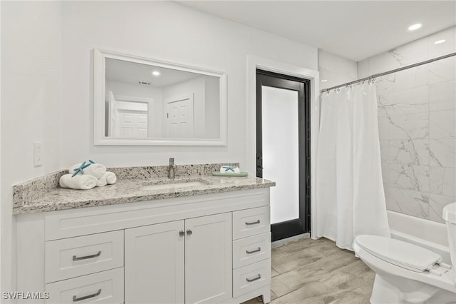 full bathroom with vanity, toilet, and shower / tub combo with curtain