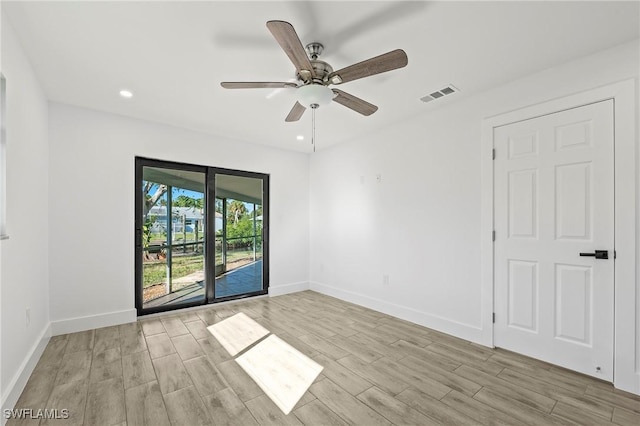 empty room featuring ceiling fan and light hardwood / wood-style floors