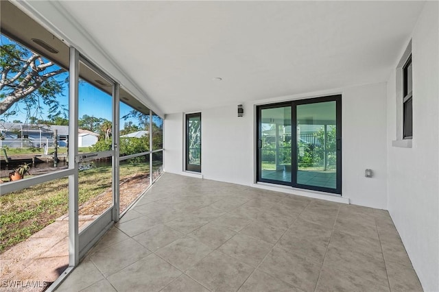 unfurnished sunroom featuring a healthy amount of sunlight