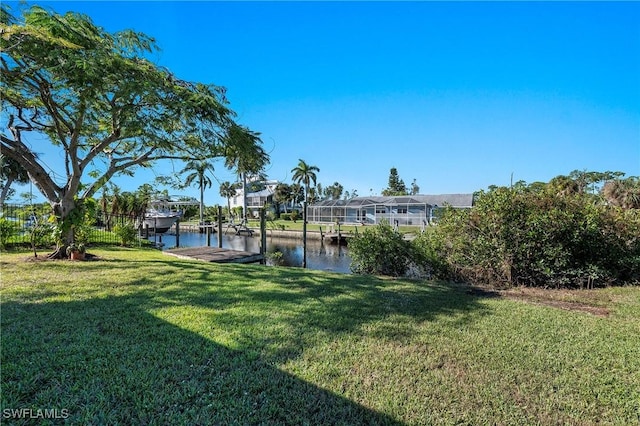 view of yard with a dock and a water view