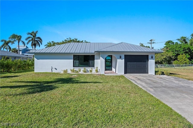 view of front of house with a garage and a front lawn