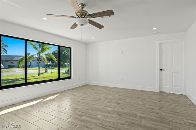 spare room featuring ceiling fan and light wood-type flooring