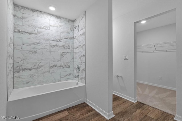 bathroom featuring hardwood / wood-style floors and tiled shower / bath