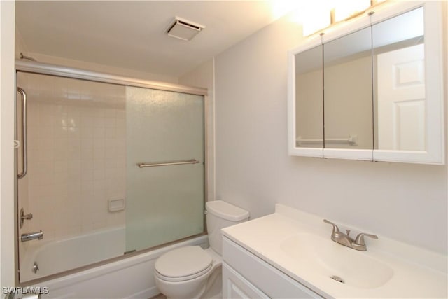 full bathroom with toilet, shower / bath combination with glass door, and vanity