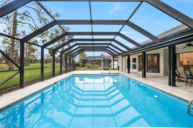 pool featuring glass enclosure and a patio