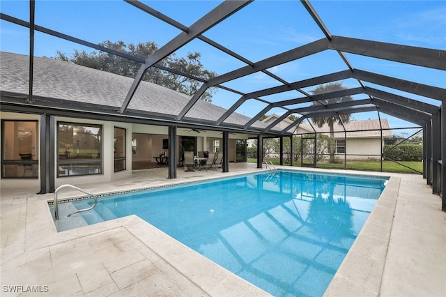 pool with glass enclosure and a patio