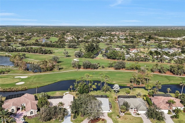 drone / aerial view with a water view and view of golf course