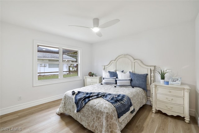 bedroom with light wood finished floors, ceiling fan, and baseboards