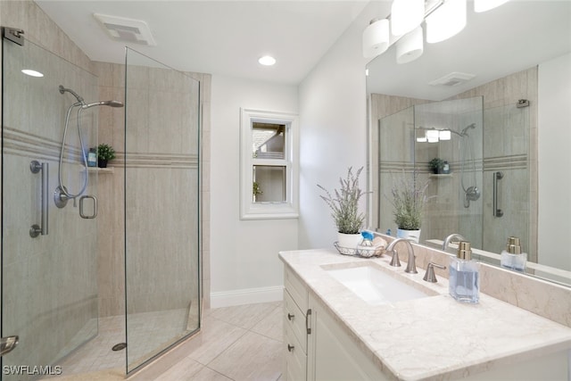 bathroom with visible vents, a shower stall, vanity, and baseboards