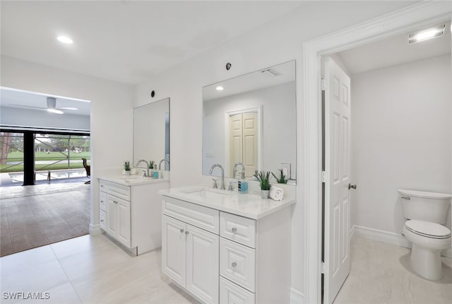 full bathroom with toilet, two vanities, visible vents, and a sink