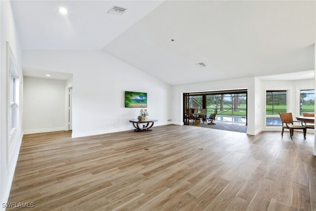 2037 Prince Dr, Naples, FL 34110 - unfurnished living room with light wood-type flooring, baseboards, high vaulted ceiling, and recessed lighting