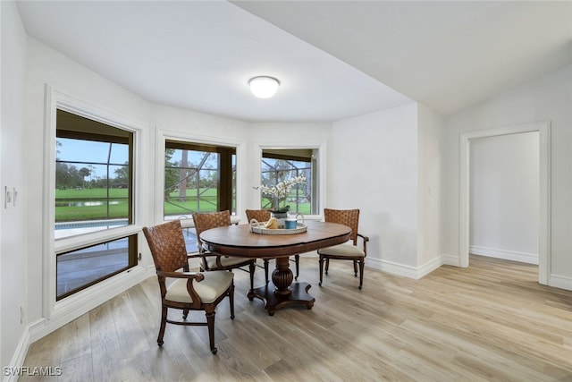 dining room featuring baseboards and light wood-type flooring