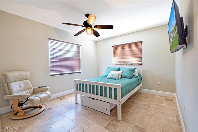 106 Pago Pago Dr W, Naples, FL 34113 - bedroom with stone tile flooring, baseboards, and a ceiling fan