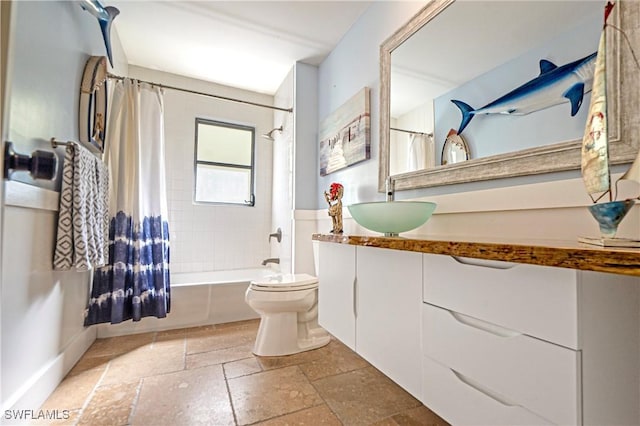 full bathroom featuring vanity, shower / bath combination with curtain, and toilet