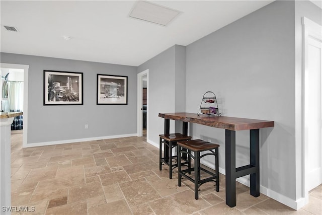 106 Pago Pago Dr W, Naples, FL 34113 - dining space featuring stone tile flooring and baseboards