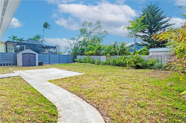 view of yard with a shed and a patio area