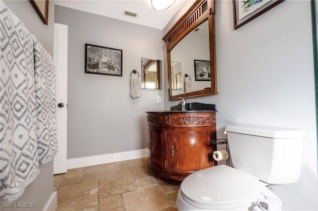 106 Pago Pago Dr W, Naples, FL 34113 - bathroom with stone tile flooring, baseboards, toilet, and vanity
