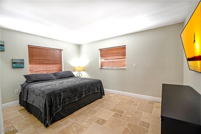 106 Pago Pago Dr W, Naples, FL 34113 - bedroom featuring stone tile floors and baseboards