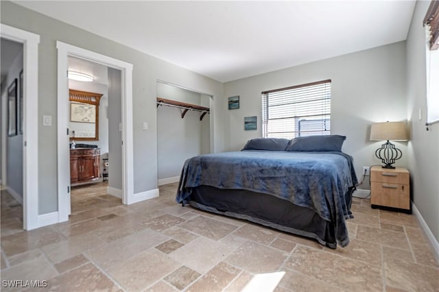 106 Pago Pago Dr W, Naples, FL 34113 - bedroom featuring stone tile floors, a closet, and baseboards