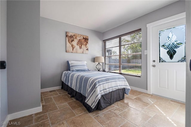 106 Pago Pago Dr W, Naples, FL 34113 - bedroom featuring stone tile flooring and baseboards