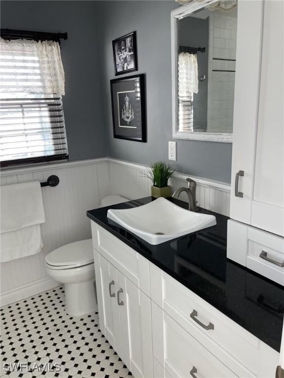 bathroom featuring toilet, vanity, and tile patterned floors