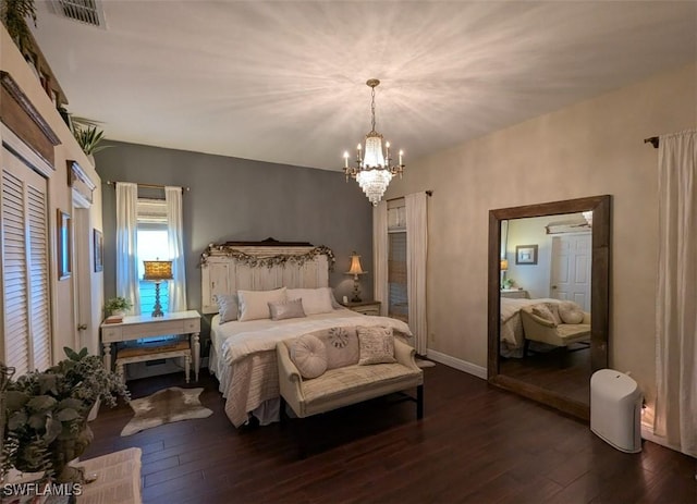 bedroom featuring a chandelier and dark hardwood / wood-style floors