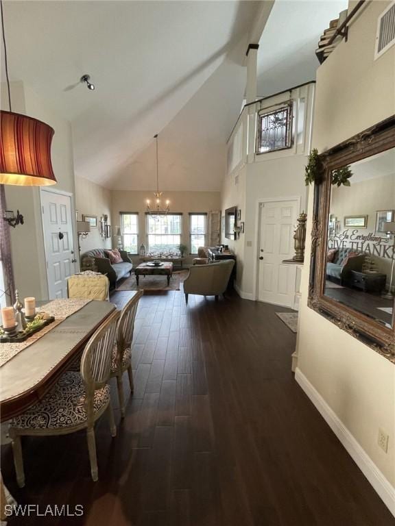 dining room featuring dark hardwood / wood-style flooring, high vaulted ceiling, and a notable chandelier