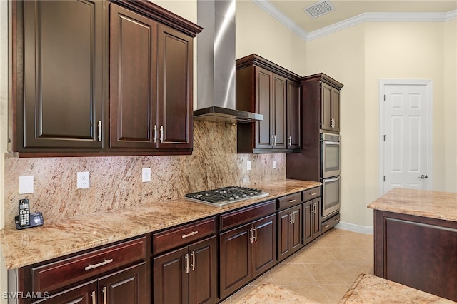 kitchen featuring backsplash, crown molding, wall chimney exhaust hood, light tile patterned floors, and appliances with stainless steel finishes