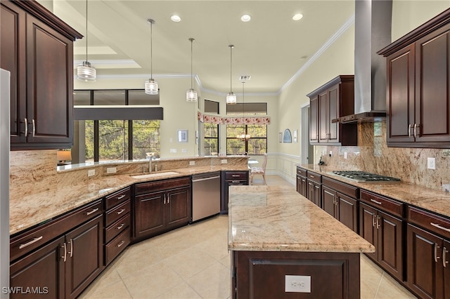 kitchen featuring kitchen peninsula, appliances with stainless steel finishes, wall chimney exhaust hood, sink, and pendant lighting