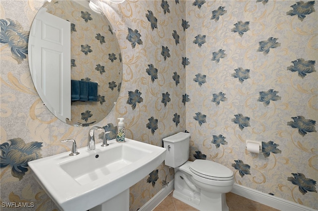 bathroom with sink, tile patterned flooring, and toilet