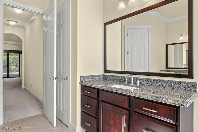 bathroom with tile patterned floors, vanity, and ornamental molding